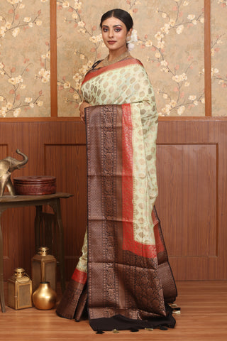 Cream Semi Georgette Banaras Saree With Brown And Red Traditional Border And Butis